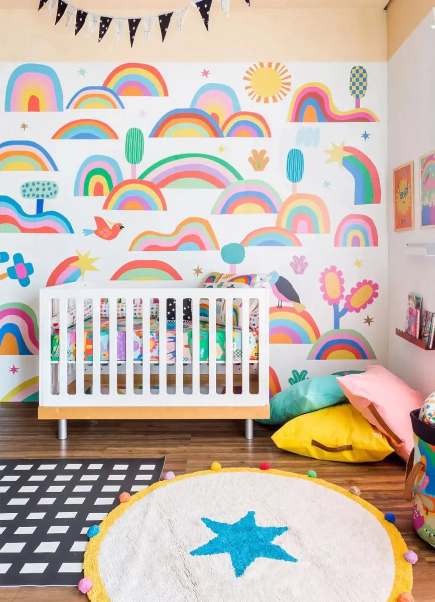 Colorful rainbow wallpaper for playroom featuring cheerful clouds, flowers, and playful designs
