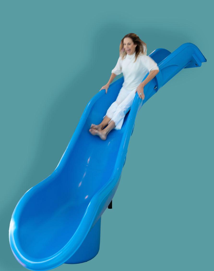 Child happily sliding down a colorful indoor playroom slide for fun and active playtime