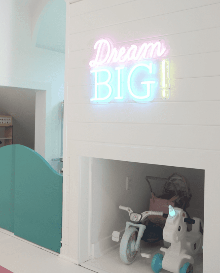 Bright Dream Big neon sign for kids illuminating a stylish playroom wall
