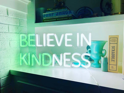 Brite Lite Tribe be kind neon sign glowing softly in a home setting to promote positivity