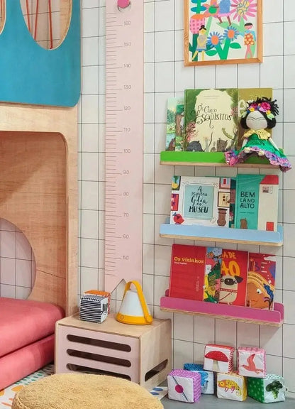 Colorful children's room featuring black grid wallpaper with playful decor and bookshelves
