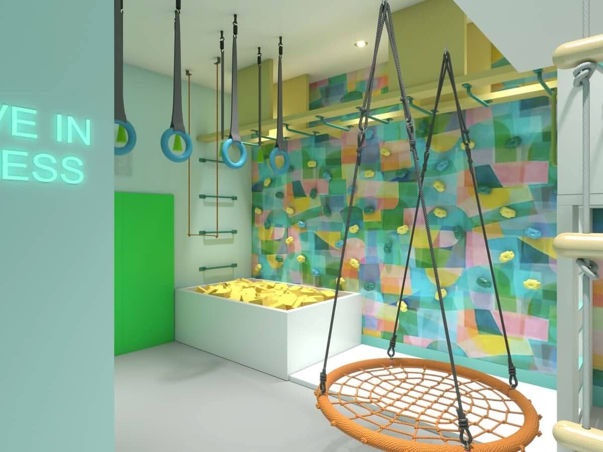 Vibrant climbing playroom design package featuring a swing, climbing wall, and sensory play area
