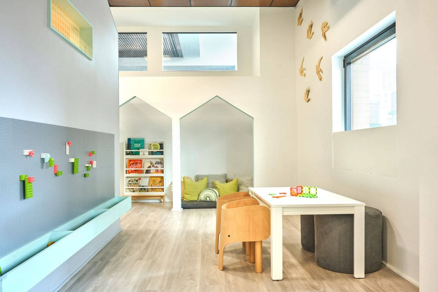 Bright communal playroom design featuring cozy seating and creative activity areas for children