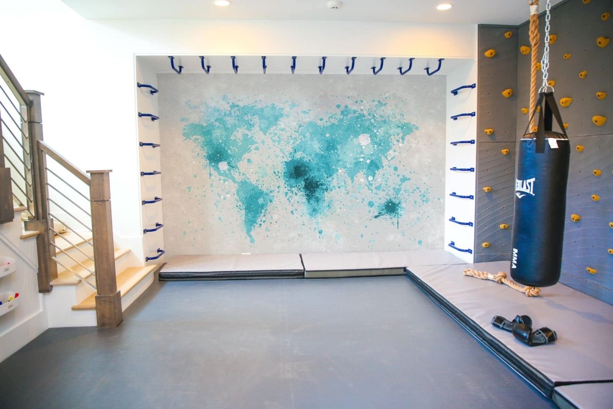 Educational world map wallpaper in blue tones on a feature wall of a gym area