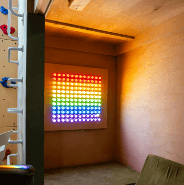 Colorful Lite-Brite peg set for kids displayed on a wall, showcasing vibrant designs
