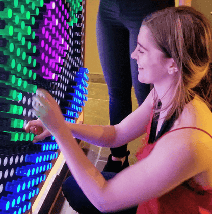 Child engaging with a colorful Lite-Brite peg set for kids, creating vibrant designs and art.