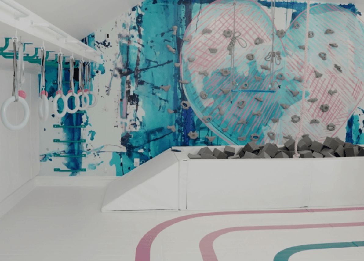 Colorful love heart wall mural creating a playful atmosphere in a children's gym