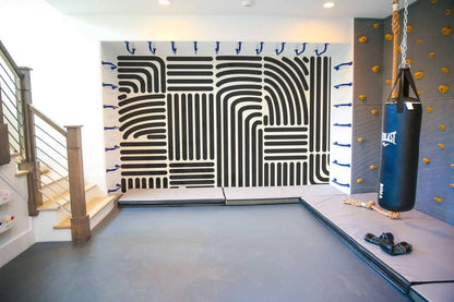 Modern playroom wallpaper featuring abstract black lines on a white backdrop in a vibrant play area