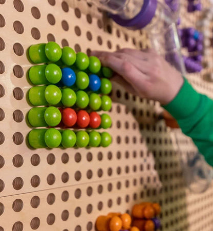 Child arranging colorful pieces on a Montessori pegboard for kids promoting hands-on learning