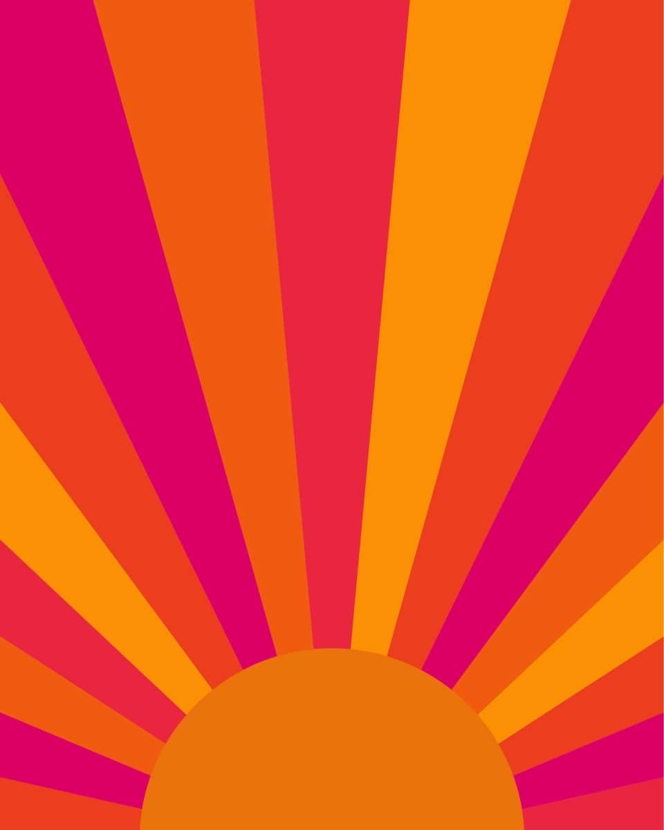 Sur La Mur Montessori playroom wallpaper featuring vibrant orange and pink sunburst design