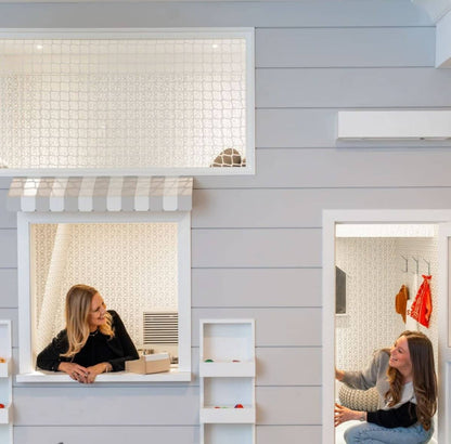 Professionals conducting a playroom design consultation in a stylish playroom setting
