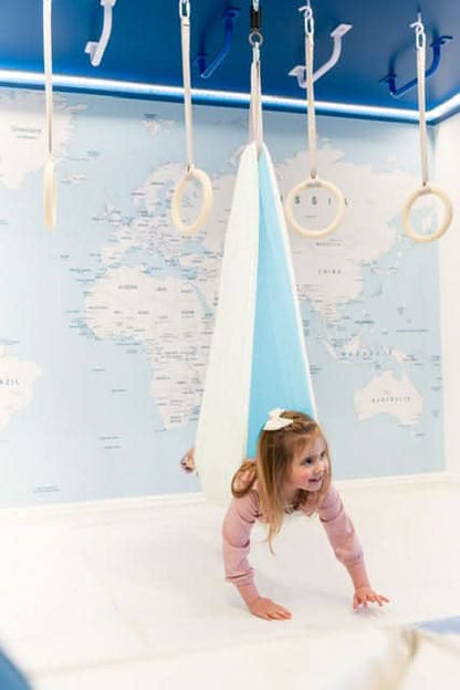 SAVOIZ sensory swing for kids designed for play and relaxation in a colorful room