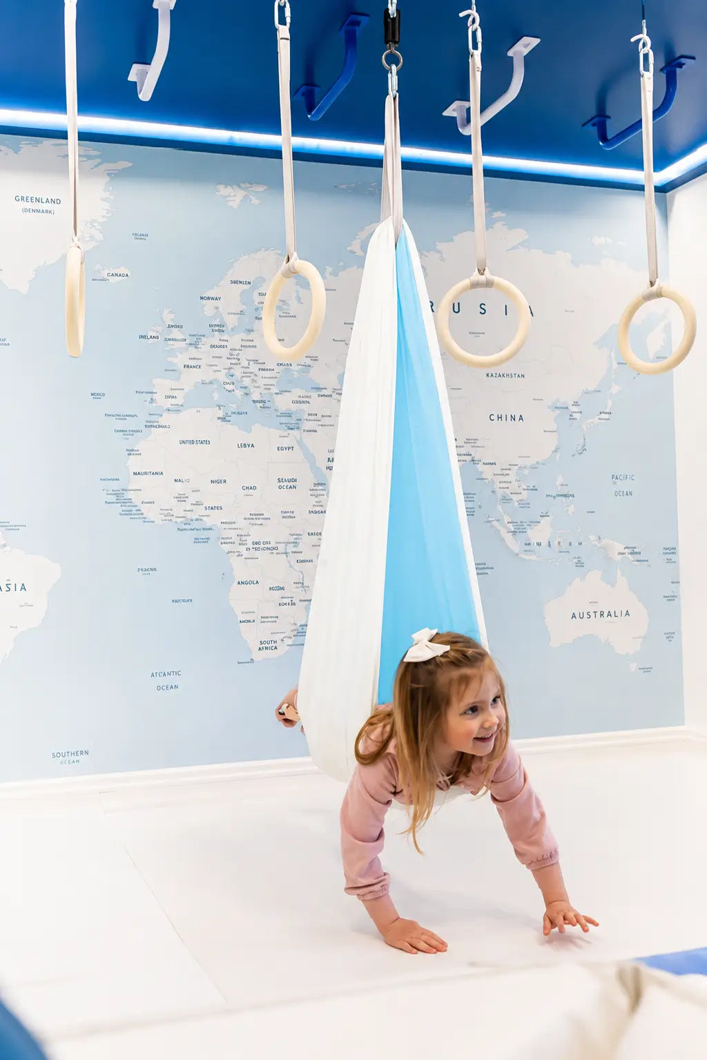 SAVOIZ sensory swing for kids designed for play and relaxation in a colorful room