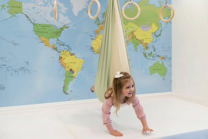 SAVOIZ sensory swing for kids in a playful indoor setting with a child exploring it