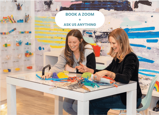 Two women engaging in a virtual playroom design consultation, creating playful designs at a table